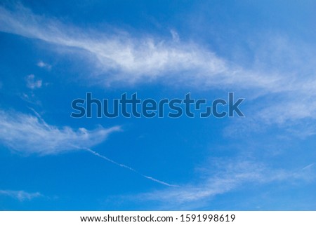 High-speed rockets run through clouds in the sky,A jet plane in the sky full of clouds,