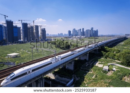 High-Speed Train Gliding Through a Modern Urban Landscape  