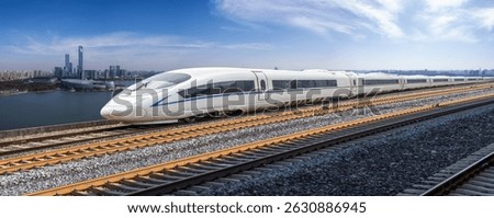 High-speed train moving fast in front of the city skyline