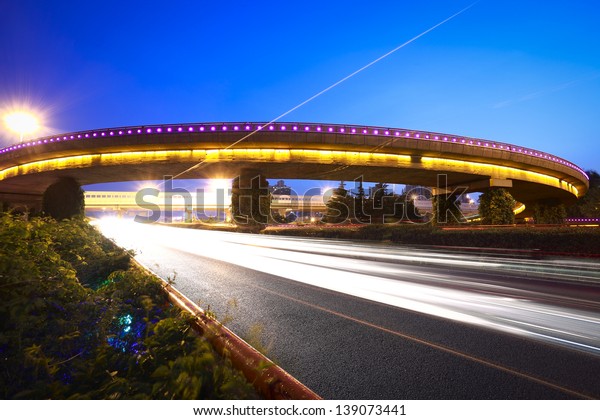 high-speed urban viaduct construction night view\
car light trails