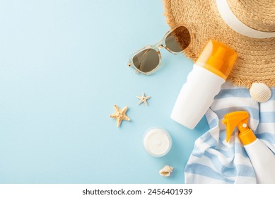 High-SPF sunscreen collection showcased with top view of sunhat, sunglasses, and beach essentials on pastel blue backdrop, ideal for UV defense and hydration - Powered by Shutterstock