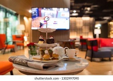 hight tea set on a table with newspaper