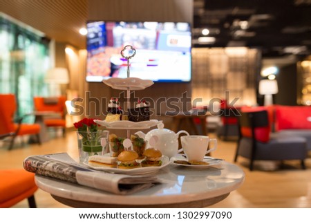 hight tea set on a table with newspaper