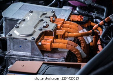 High-tech electric car power inverter under the hood. See massive power cables, battery, and electric motor connections up close. Perfect for EV industry and technology ads.