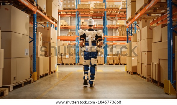 High-Tech Futuristic Warehouse: Worker Wearing\
Advanced Full Body Powered exoskeleton, Walks with Heavy Cardboard\
Box. Exosuit amplifies Human Performance, strength, Eliminates Work\
Related Injuries