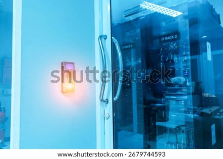 High-tech security access system on a glass door in a data center, showcasing advanced technology for secure entry to IT equipment and server management.