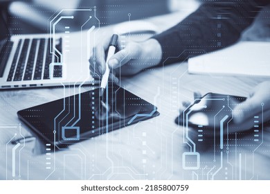 High-tech sensor circuit board panel. Close up of male hands using tablet and smartphone with hologram. Technology and digital communication concept on blurry background. Double exposure