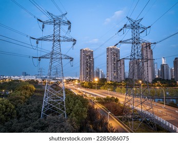 high-voltage power lines. high voltage electric transmission tower at night