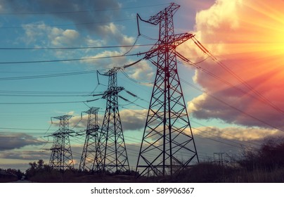  high-voltage  power lines at sunset. electricity distribution station .