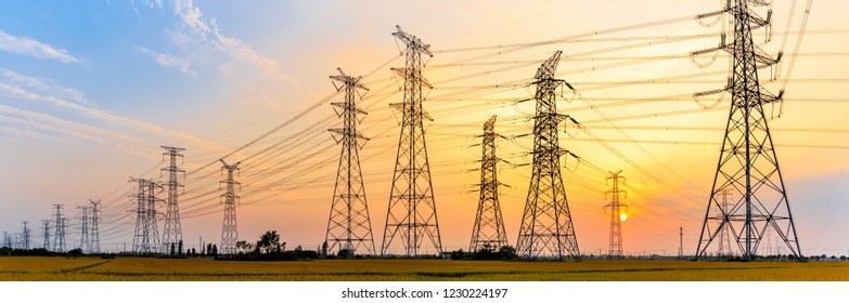 high-voltage power lines at sunset,high voltage electric transmission tower - Shutterstock ID 1230224197