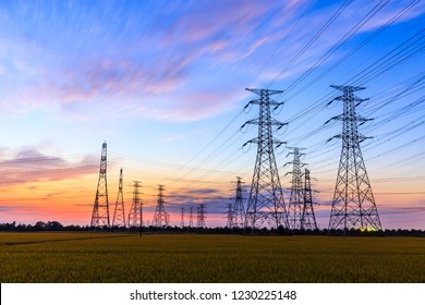 high-voltage power lines at sunset,high voltage electric transmission tower - Shutterstock ID 1230225148