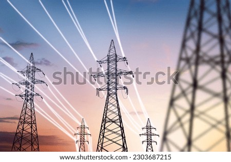 high-voltage power pylons with luminous wires against the backdrop of the sunset sky. energy infrastructure concept