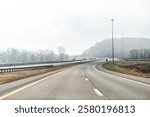 Highway 33 east road in fog on foggy morning near Columbus Ohio with cars trucks traffic in autumn fall