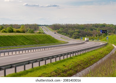 Highway with ascent and descent, bumpers and road signs. Trucks are moving along - Shutterstock ID 2081403016