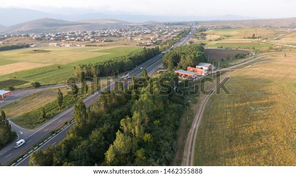 Highway asphalt\
two way road with cars and\
trucks