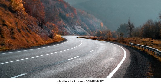 Highway In Autumn Mountains. Transportation Background. New Winding Free Road.