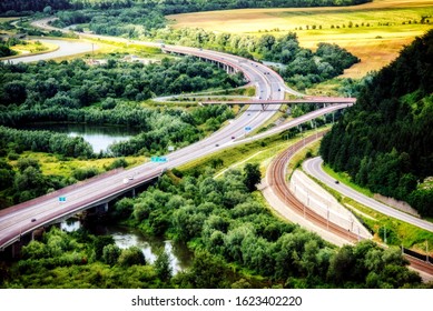 highway between meadows and trees