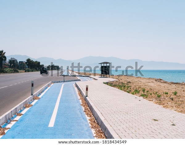 A highway with bicycle road along the\
Mediterranean Sea near the town of Finike in\
Turkey