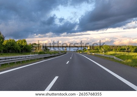 Highway with bridge. Empty road at sunset. Roadscape panorama
