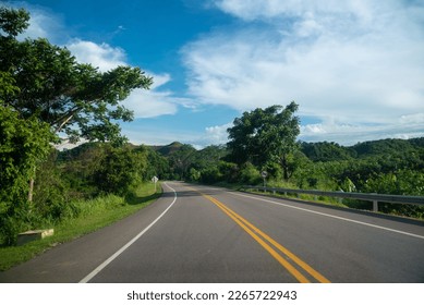 Highway in the Colombian countryside with a no overtaking traffic sign on the road. - Shutterstock ID 2265722943