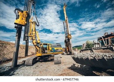 Highway construction site with heavy duty machinery. Two Rotary drills, bulldozer and excavator working  - Shutterstock ID 679457746