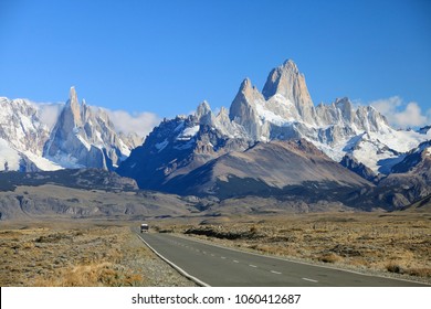 The highway crosses the Patagonia and leads to snow-capped peaks of Mount Fitzroy. Over the road flying flock of Andean condors. - Powered by Shutterstock