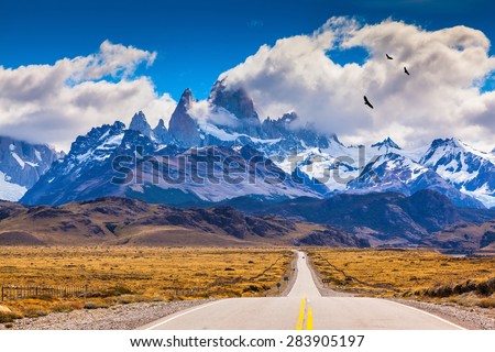  The highway crosses the Patagonia and leads to snow-capped peaks of Mount Fitzroy. Over the road flying flock of Andean condors