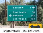 Highway directional sign pointing towards Barstow, Needles or Las Vegas in California’s Mojave desert.  