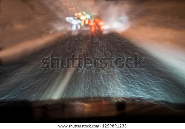 highway, driving at\
night during the\
blizzard