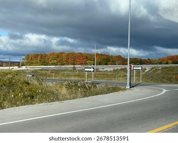 Highway with Fall Trees and Clouds