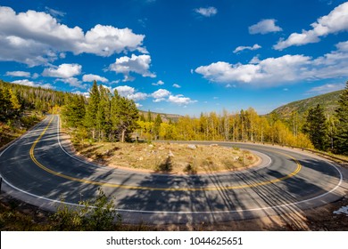 Highway with hairpin turn (switchback) at autumn sunny day in Rocky Mountain National Park. Colorado, USA. 