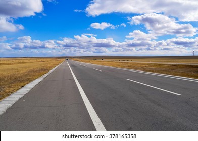 Highway in inner Mongolia, it was autumn, grasses were all turned yellow, and sky is high and clear with many clouds flowing.