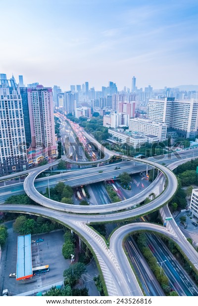 a highway interchange in guangzhou at dusk with\
vehicles motion blur