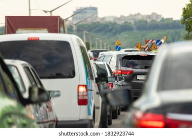 Highway interstate road with car traffic jam and Kiev on background. Motorway bumber barrier gridlock due country border control point. Vehicle crash accident and queue bottleneck on freeway