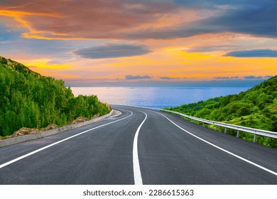 highway landscape at colorful sunset. Road view on the sea. colorful seascape with beautiful road. highway view on ocean beach. coastal road in europe. beautiful nature scenery in the mediterranean. - Shutterstock ID 2286615363