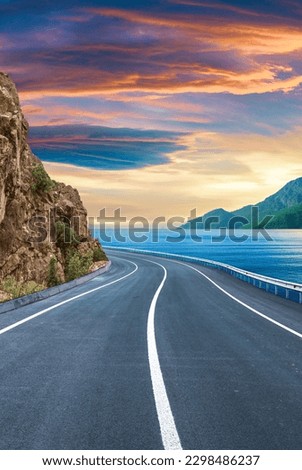 highway landscape at colorful sunset. traveling on the holiday road in summer. Nature scenery on ocean beach. Road landscape on beach. Stunning sea with summer vacation. seascape with beautiful road.