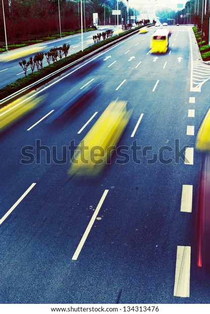 Highway with lots of cars. Blue tint, high\
contrast and motion blur to rise\
speed.