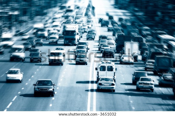Highway with lots of cars. Blue tint, high
contrast and motion blur to rise
speed.