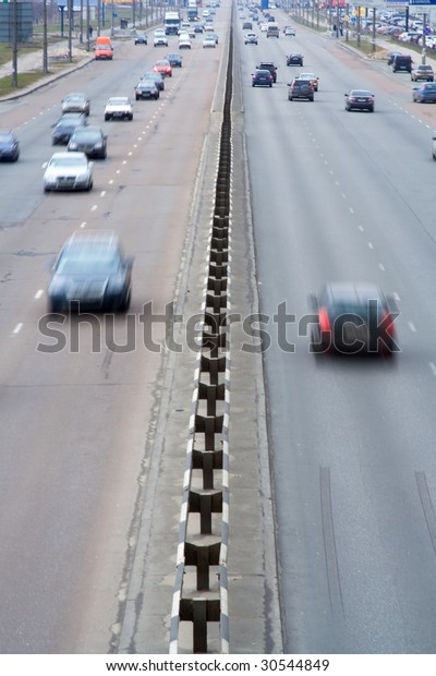 highway multi lanes road with\
many moving cars in rush motion blur effect speed and traffic\
vertical