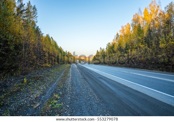 Highway and\
natural landscape. Warm time of the\
year.