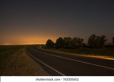 Highway At Night In The Countryside With Stars In The Sky