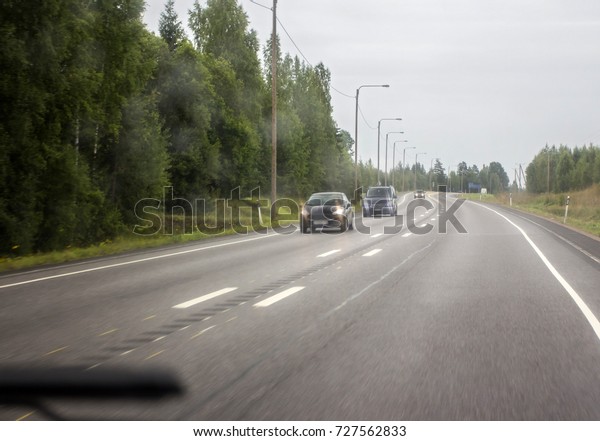 Highway\
in northern Europe. View through the\
windshield