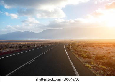 Highway on the deserted landscape on the sunset on Fuerteventura island in Spain - Powered by Shutterstock