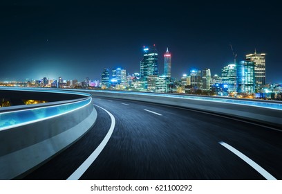 Highway overpass modern city skyline background . Night scene .