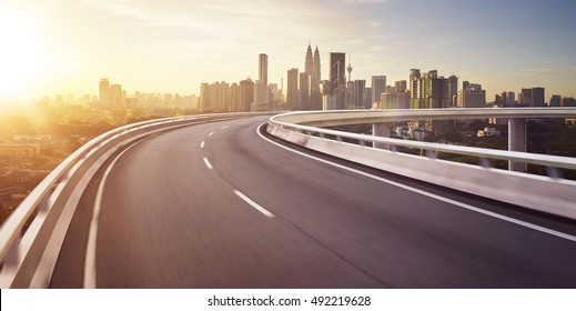 Highway overpass motion blur with city background . sunrise scene .