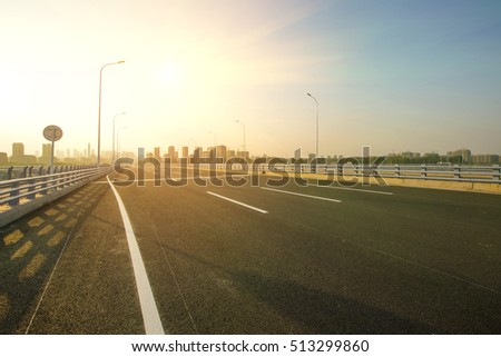 Highway overpass motion blur with city background