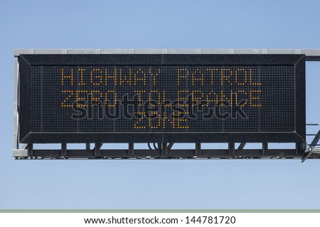 Highway Patrol zero tolerance zone electric warning sign.