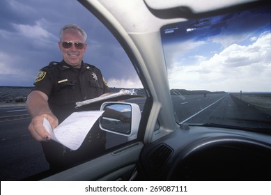 Highway Patrolman Gives A Speeding Ticket