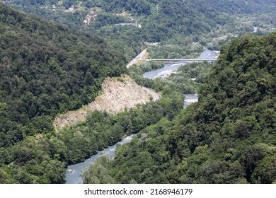 A Highway In A Picturesque Mountainous Area Along A Clear Blue River. Sochi, Krasnaya Polyana, Russia.