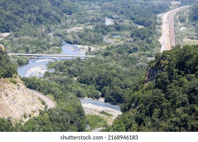 A Highway In A Picturesque Mountainous Area Along A Clear Blue River. Sochi, Krasnaya Polyana, Russia.